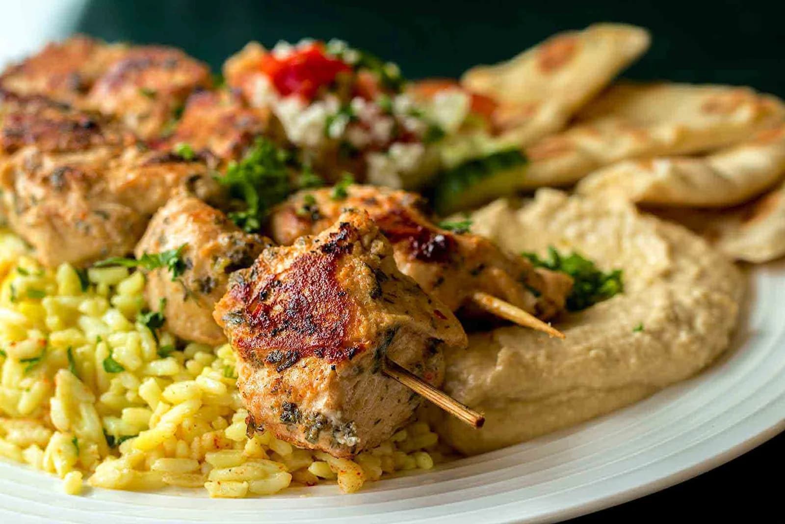 Grilled chicken kebabs, rice, hummus and pita