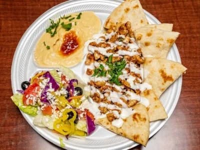 Chicken shawarma platter with hummus, rice, salad and pita